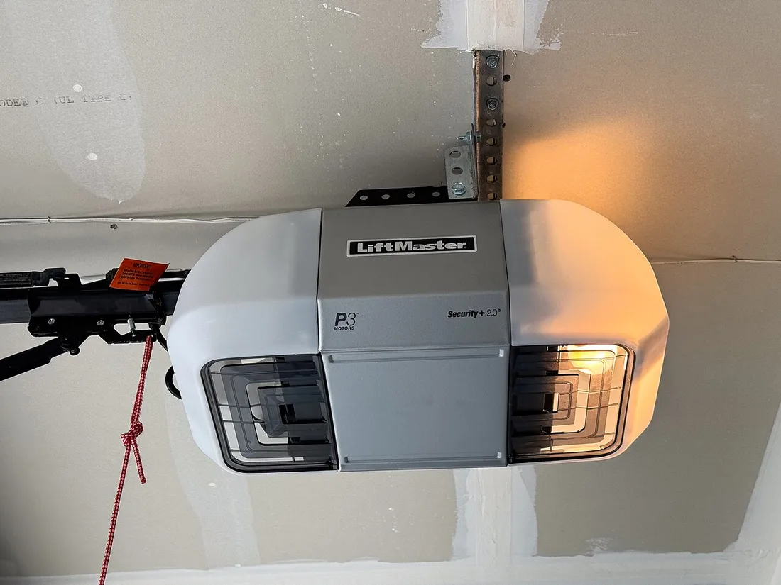 A ceiling-mounted LiftMaster garage door opener and its drive rail