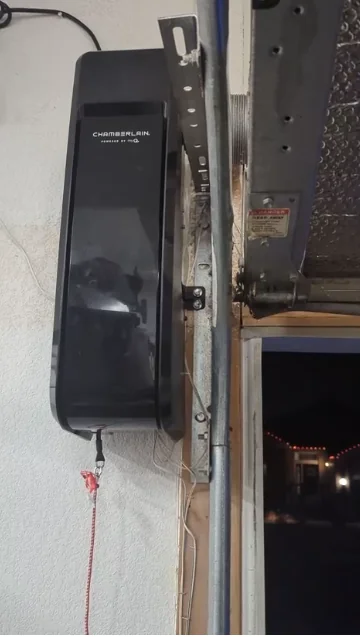 Wall-mounted Chamberlain opener beside an open garage door