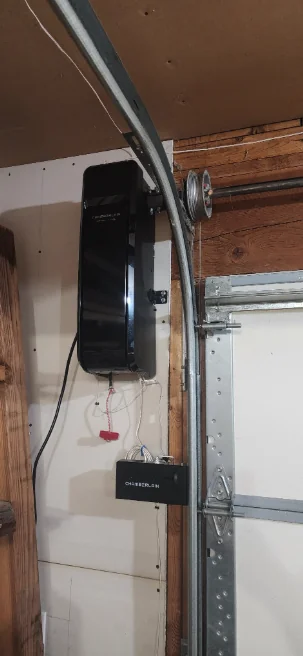 Chamberlain side-mount opener and automatic door lock beside the garage door track