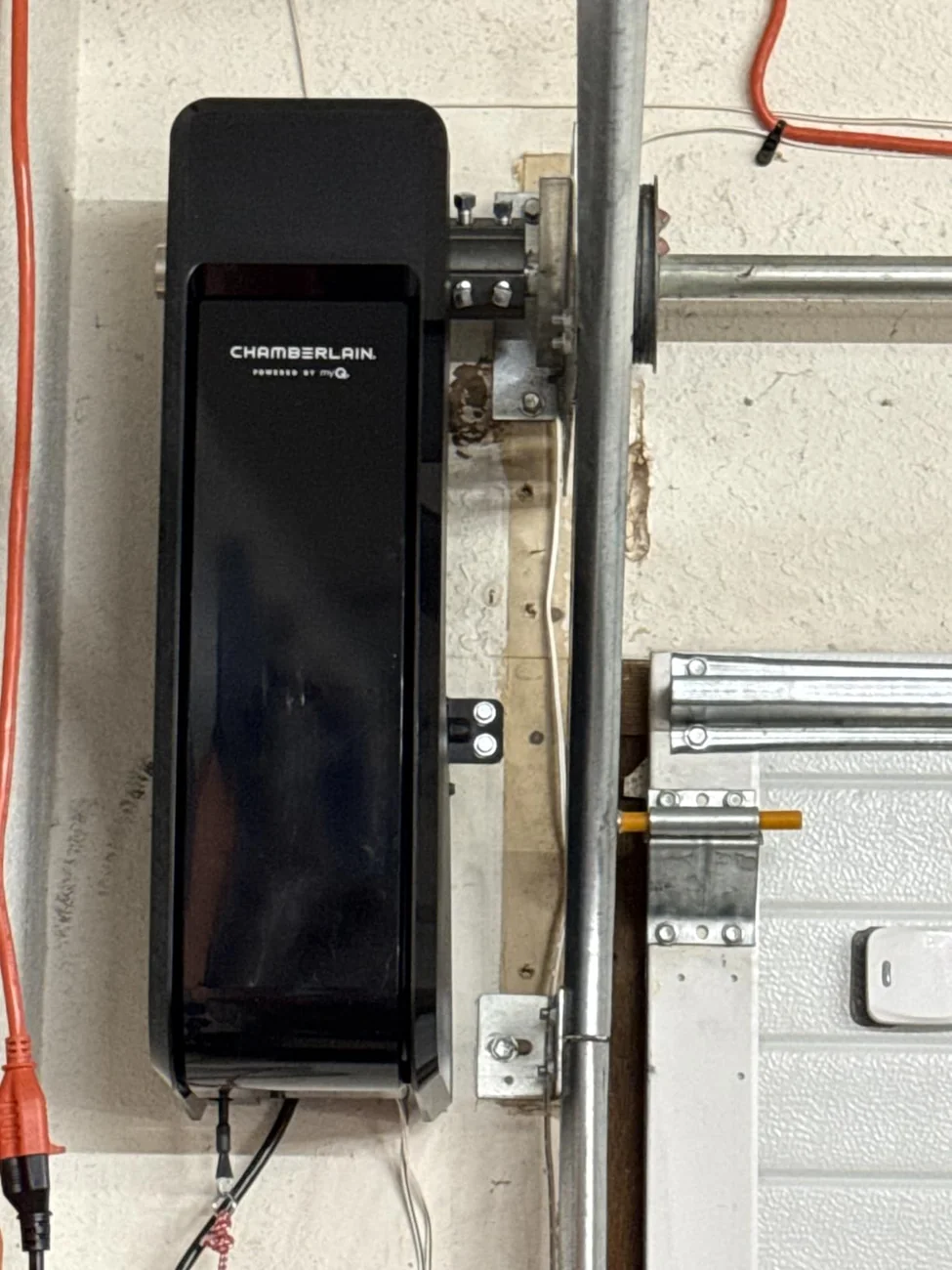 Close view of an installed Chamberlain side-mount opener and automatic garage door lock